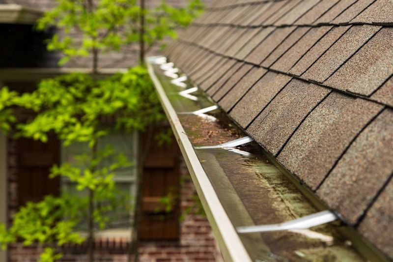 A blocked gutter on the roof of a house